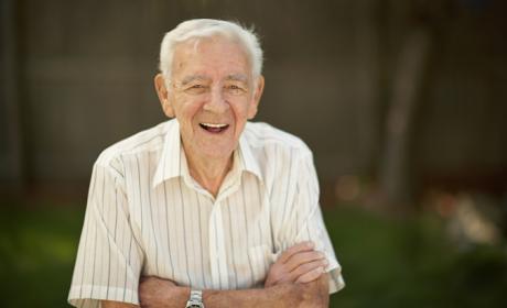 Smiling older man with folded arms
