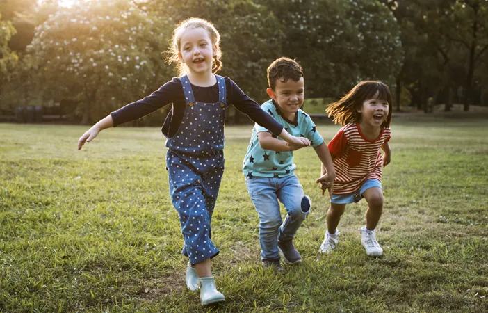 3 children playing on grass