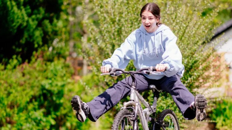 A young person riding a bike