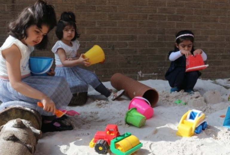 Young children playing in the sand