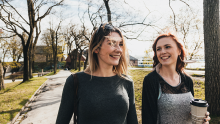 Two women out walking in a park, smiling