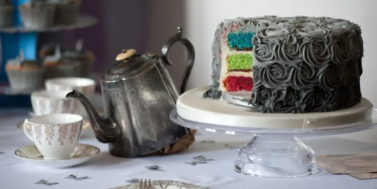Image of grey cake with rainbow centre
