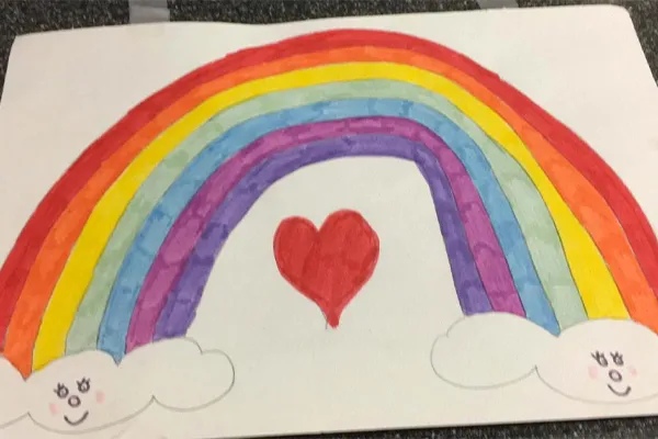 Hand drawn rainbow with smiling clouds at each end