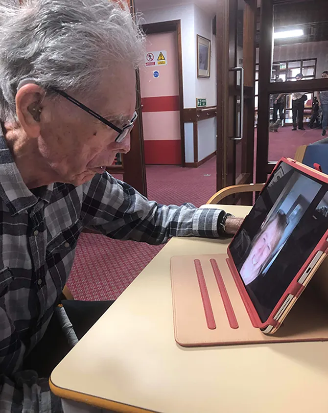 A resident connects with family over a video call