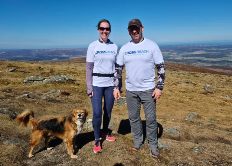 The Wrights and their dog on top of a summit