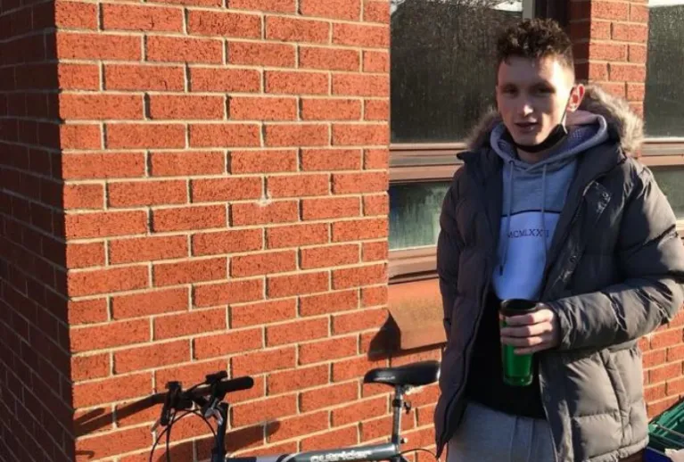 Gavin standing beside a bike